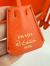 PRADA TESSUTO NYLON BUCKET CROSSBODY IN ORANGE